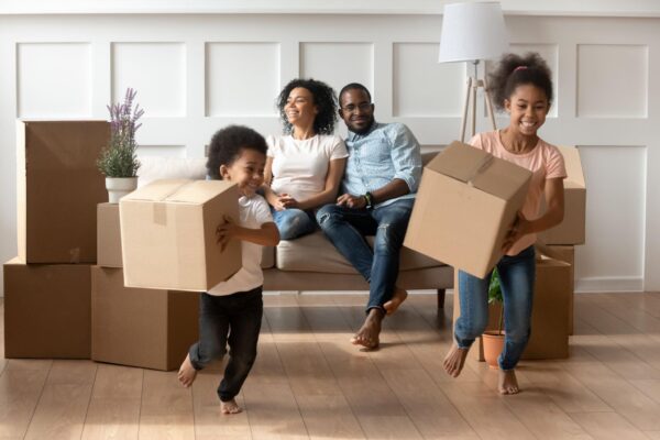 happy little african kids holding boxes play on moving day - Home - Ayokunle Homes