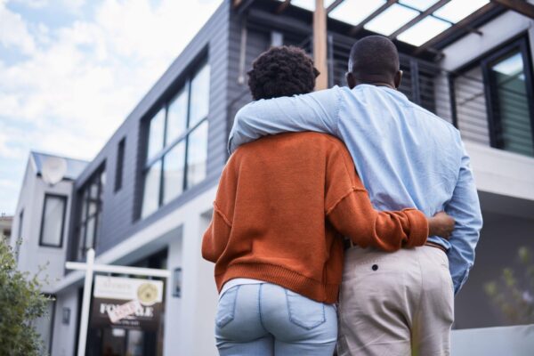 shot of a young couple standing outside their new home - Home - Ayokunle Homes